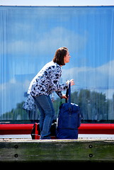 Image showing Female tourist with luggage.