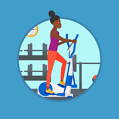 Image showing Woman exercising on elliptical trainer.