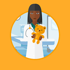 Image showing Pediatrician doctor holding teddy bear.