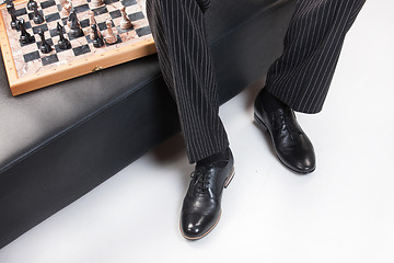 Image showing Man\'s Legs And Chess