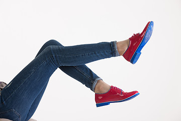 Image showing Woman\'s Legs In Blue Jeans And Red Shoes