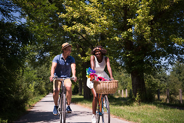 Image showing Young multiethnic couple having a bike ride in nature