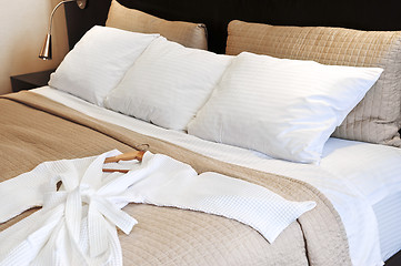 Image showing Hotel bed with bathrobe