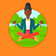 Image showing Business woman meditating in lotus position.