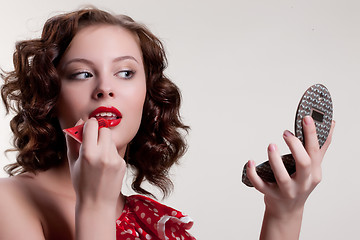 Image showing Young Woman Applying Cosmetics