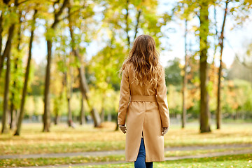 Image showing beautiful young woman walking in autumn park