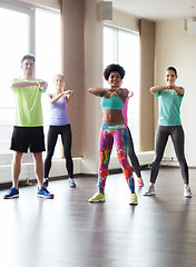 Image showing group of smiling people dancing in gym or studio