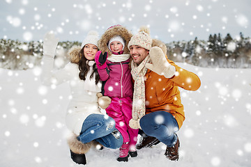 Image showing happy family waving hands outdoors in winter