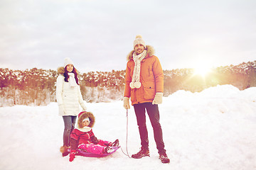 Image showing happy family with sled walking in winter outdoors