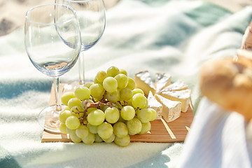 Image showing picnic with wine glasses and food on beach