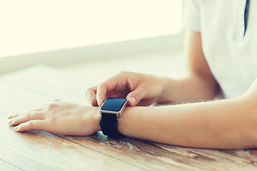 Image showing close up of hands setting smart watch