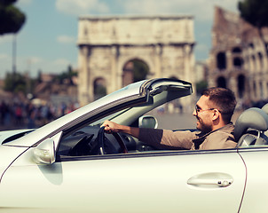 Image showing happy man driving cabriolet car over city of rome