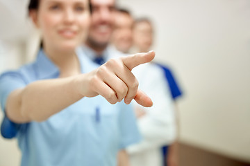 Image showing close up of doctor pointing finger at hospital