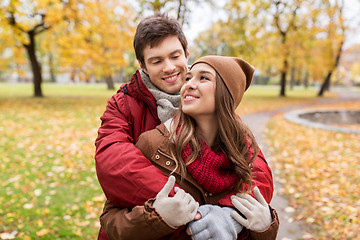 Image showing happy young couple hugging in autumn park