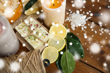 Image showing natural soap and candles on wood