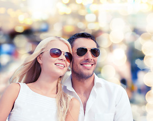 Image showing happy couple in shades over lights background