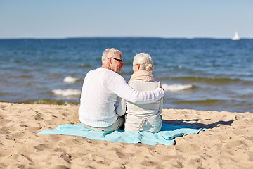 Image showing happy senior couple hugging on summer beach