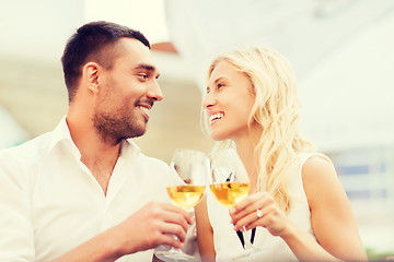 Image showing happy couple clinking glasses at restaurant lounge
