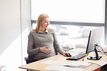 Image showing pregnant businesswoman with computer at office