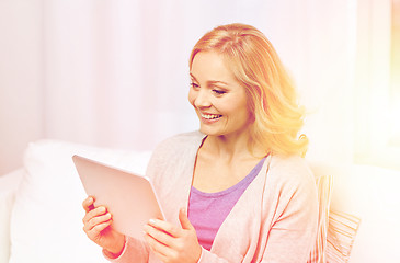 Image showing happy middle aged woman with tablet pc at home