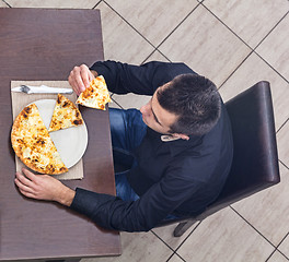 Image showing Young Man Eating Pizza