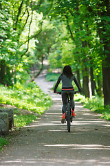 Image showing cyclist woman riding a bicycle in park