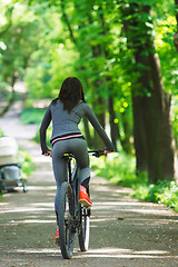 Image showing cyclist woman riding a bicycle in park