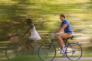 Image showing Young multiethnic couple having a bike ride in nature