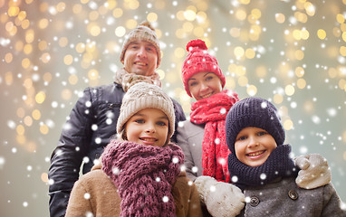 Image showing happy family over christmas lights and snow