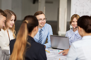 Image showing architects with laptop and blueprint at office