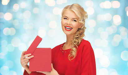 Image showing happy smiling woman in red dress with gift box