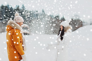 Image showing happy couple playing with snow in winter