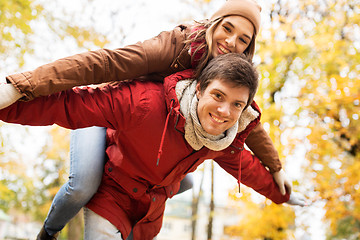 Image showing happy young couple having fun in autumn park