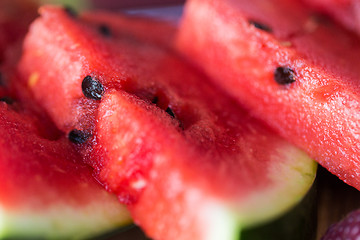 Image showing close up of watermelon slices on wooden table