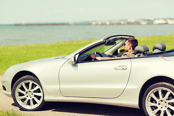 Image showing happy man driving cabriolet car outdoors