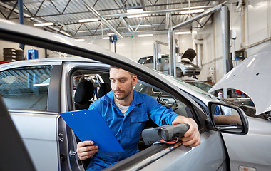 Image showing mechanic man with diagnostic scanner at car shop