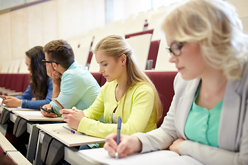 Image showing student girl with smartphone at lecture