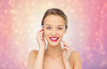 Image showing smiling young woman with pink lipstick on lips