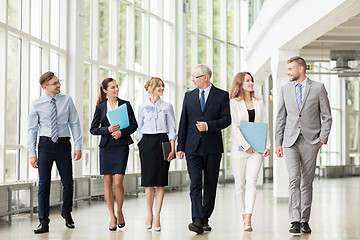 Image showing business people walking along office building