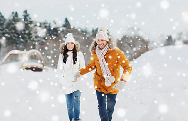 Image showing happy couple running over winter background