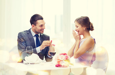 Image showing man proposing to his girlfriend at restaurant