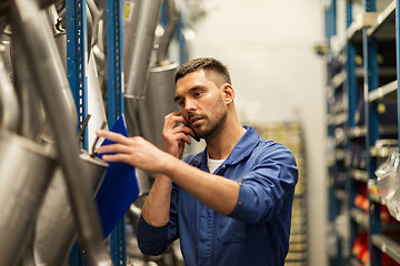 Image showing auto mechanic with clipboard at car workshop