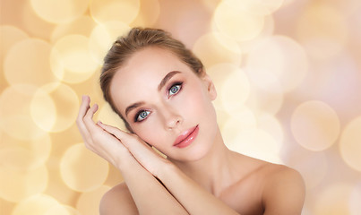 Image showing beautiful woman face and hands over lights