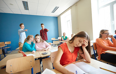 Image showing students gossiping behind classmate back at school