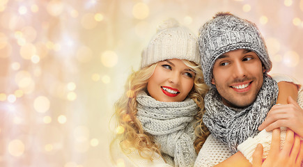 Image showing happy family couple in winter clothes hugging