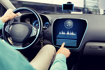 Image showing close up of man driving car with audio system