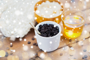 Image showing coffee scrub in cup and honey on wood