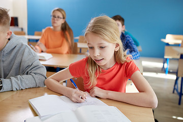 Image showing student girl with book writing school test