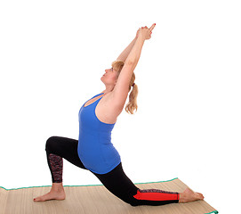Image showing Yoga trainer showing stretching.