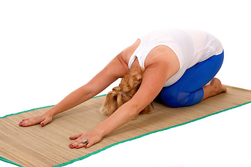 Image showing Yoga trainer kneeling on stomach.